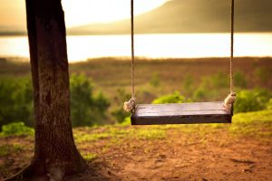 Children swing in the park (vintage tone)